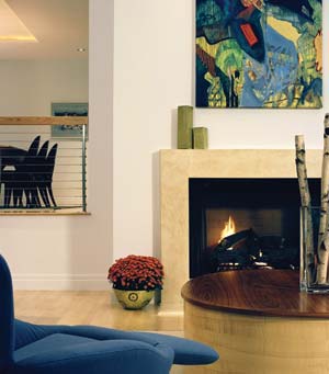 The fireplace has a recycled-concrete material, which is key to retaining and radiating heat in the great room during winter. The blue, Cassina "Dodo" chair reclines flat and has an optional footrest.